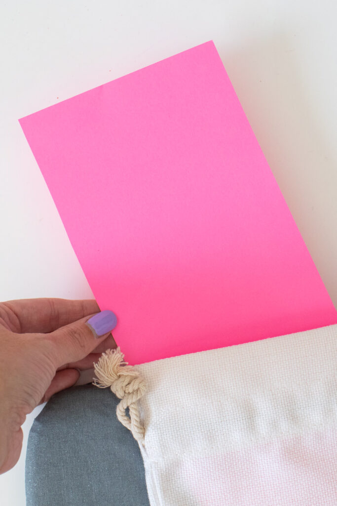 inserting cardstock into wine bag for ironing