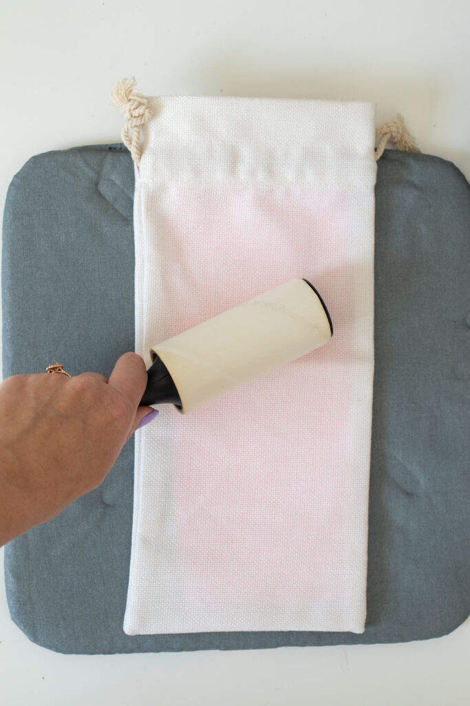 hand rolling away lint from DIY wine bag packaging