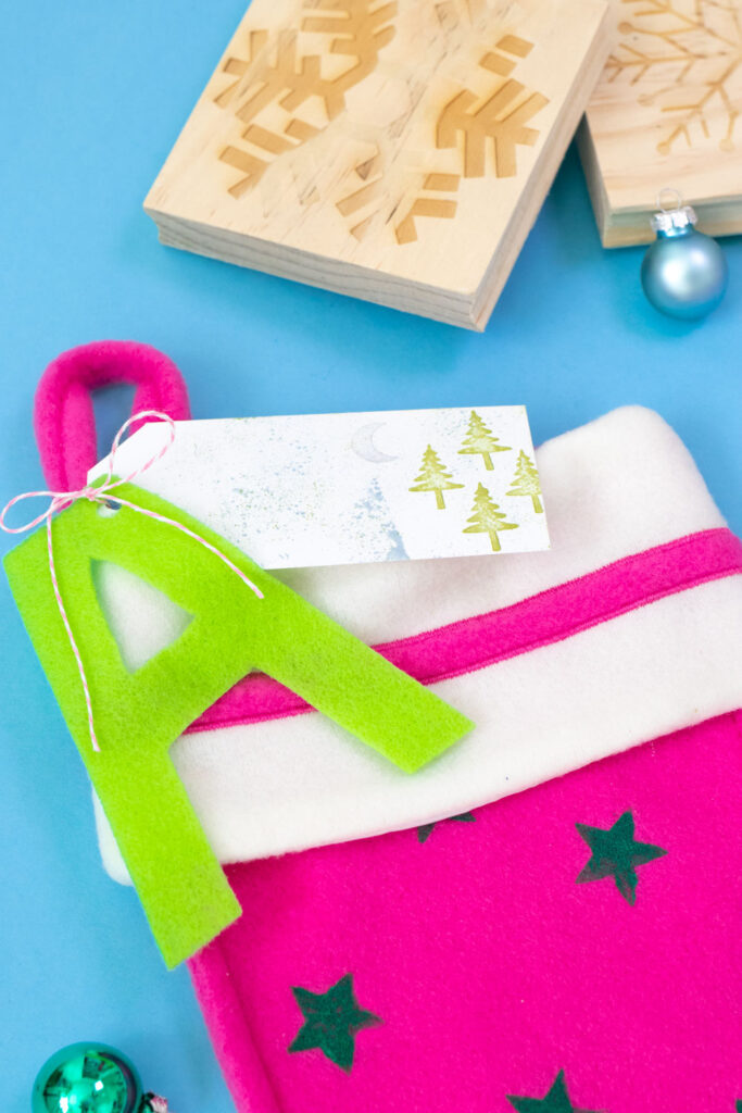 closeup of stamped tag and felt letter on stocking
