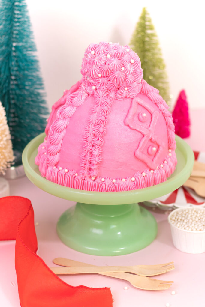slight overhead view of pom pom cupcake on top of winter hat design