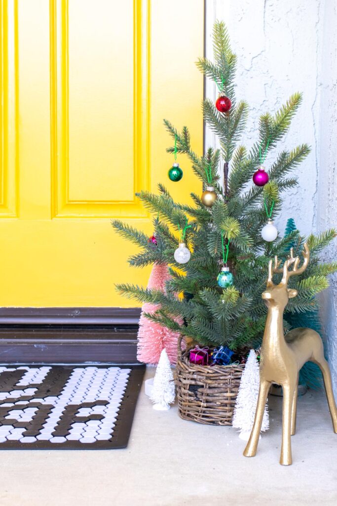 simple christmas tree in front of modernized front door