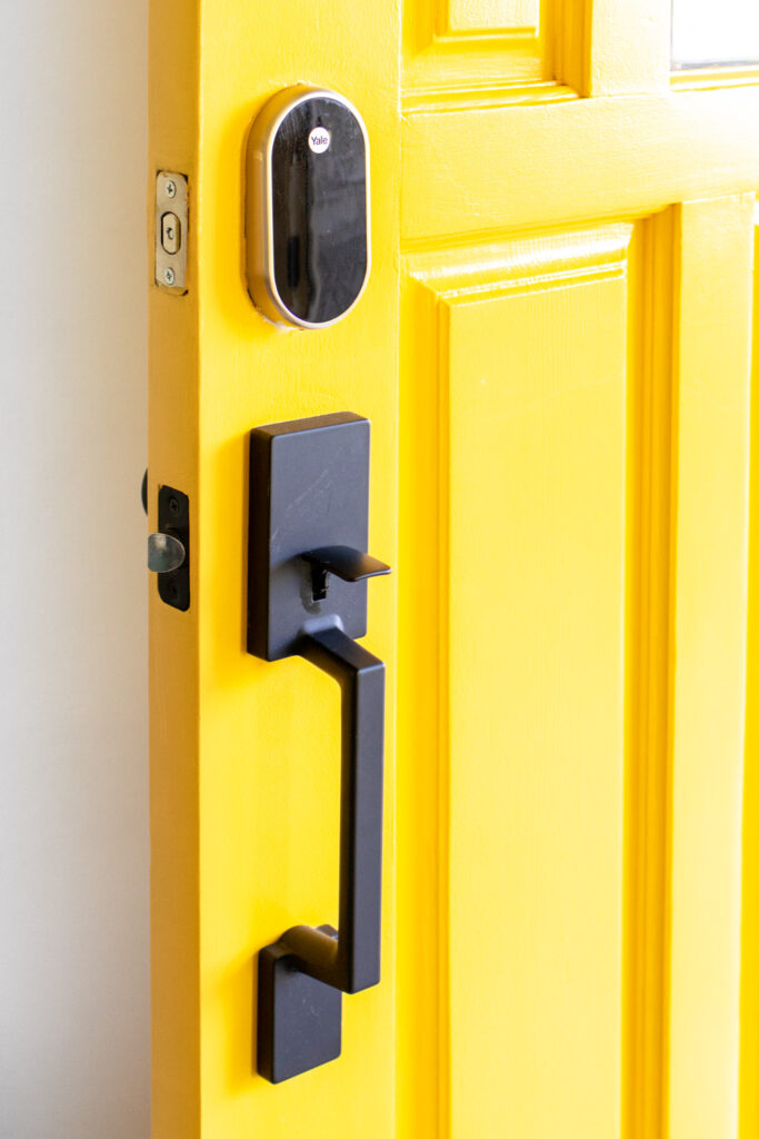 modern front door hardware on bright front door
