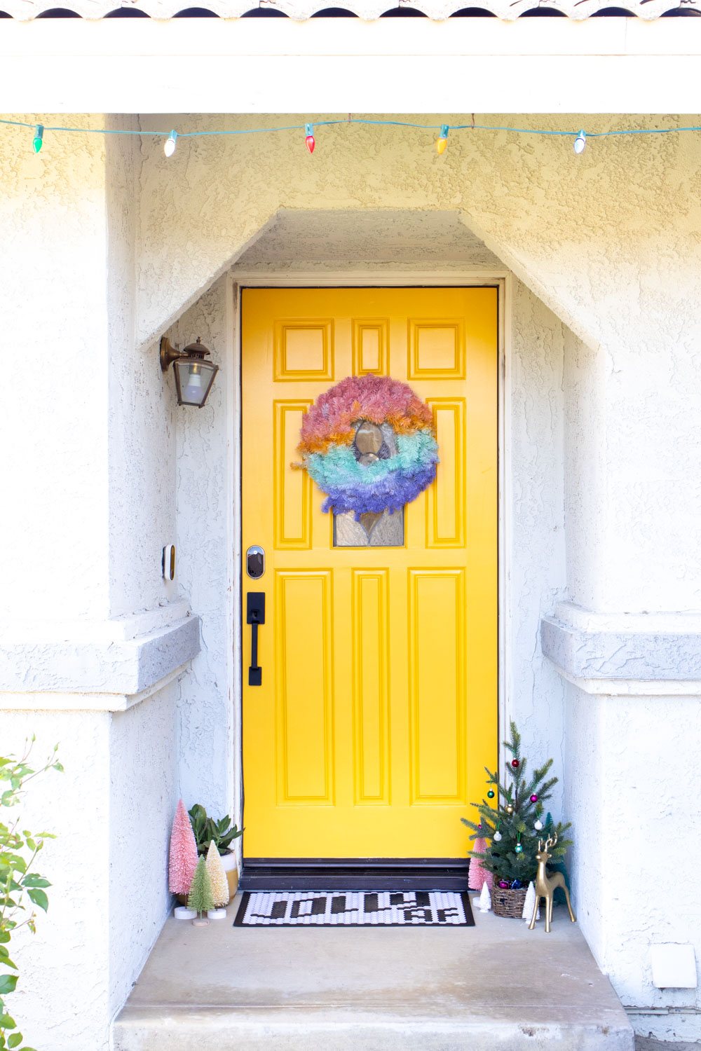 bright yellow modernized front door with modern door hardware