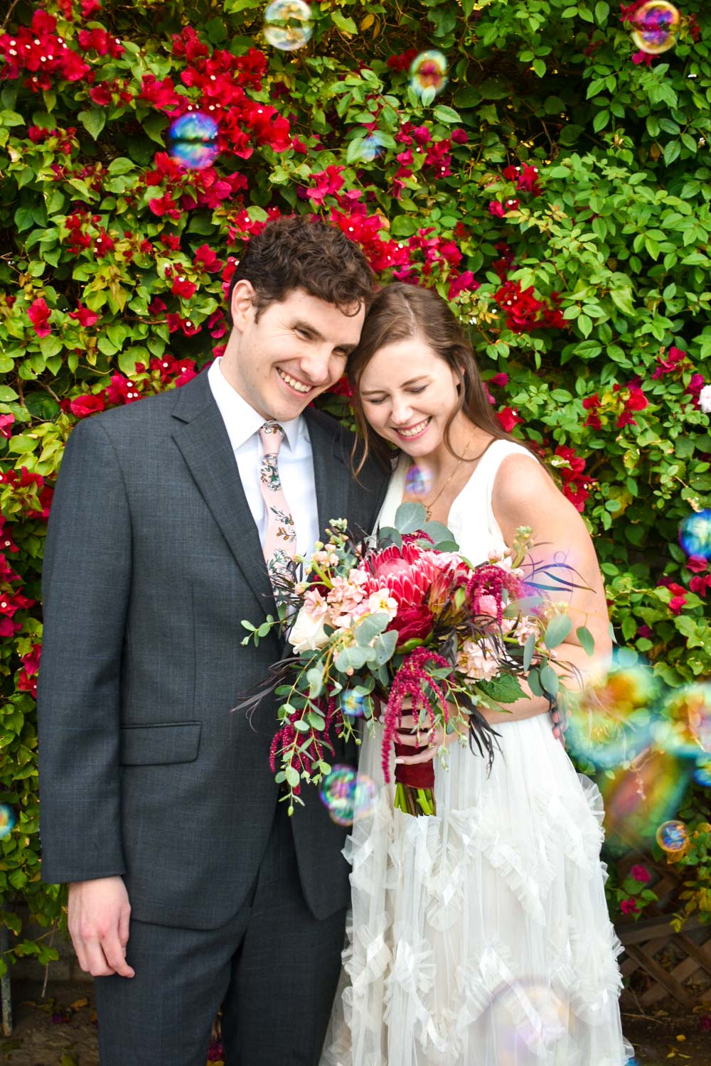 bride and groom surrounded by bubbles