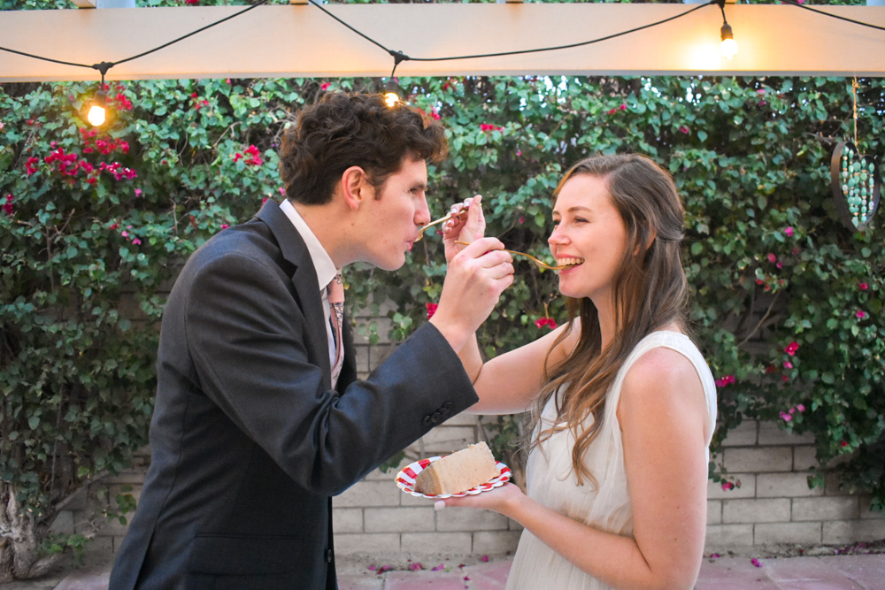couple sharing the first slice of wedding cake