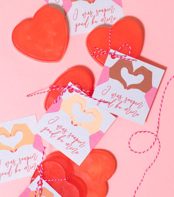 covid valentines with soap arranged on pink background