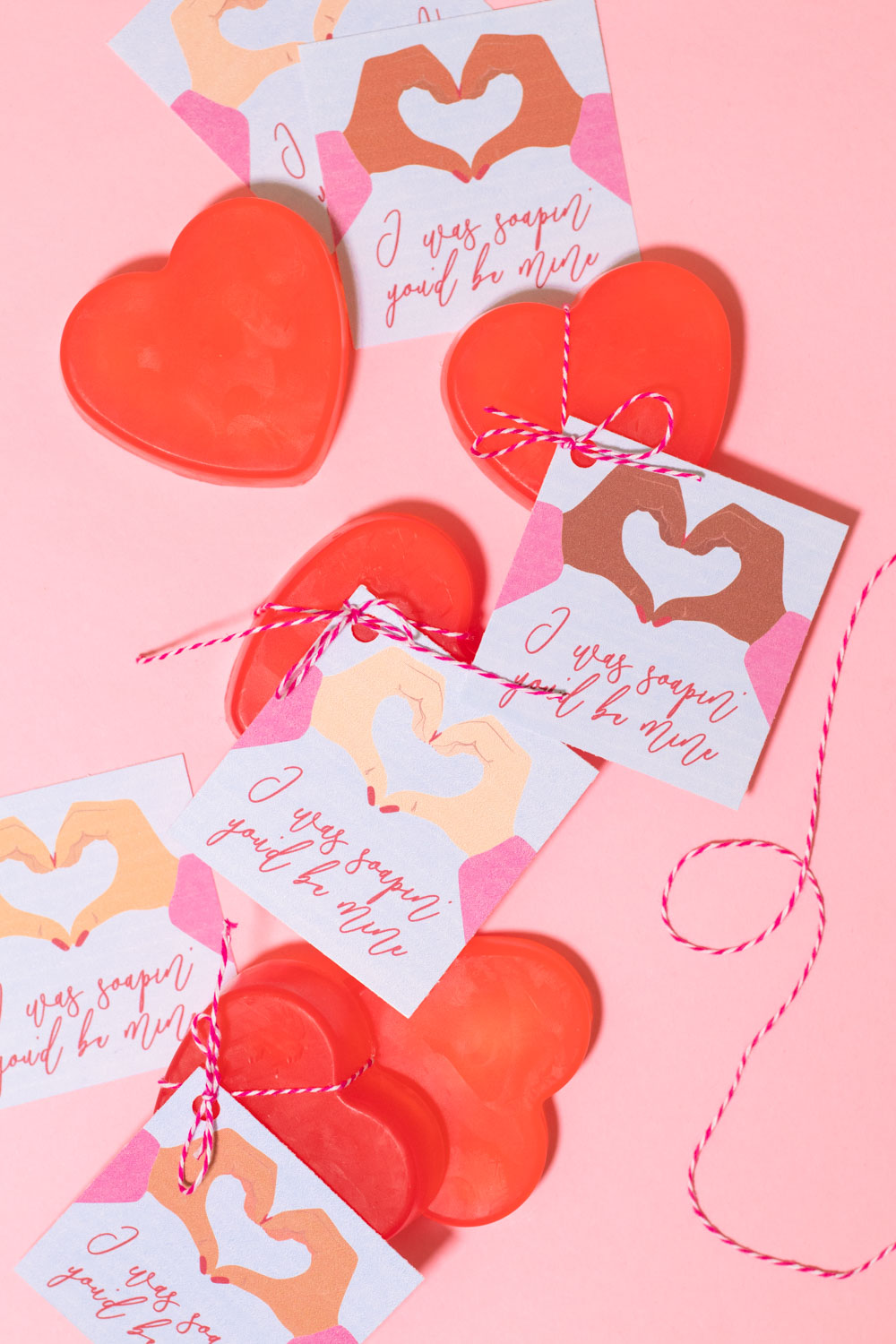 covid valentines with soap arranged on pink background