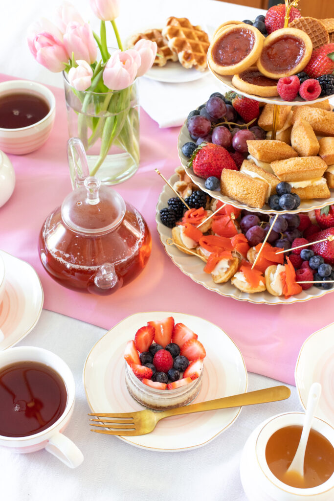 overhead photo of cheesecake and spring tea party snacks
