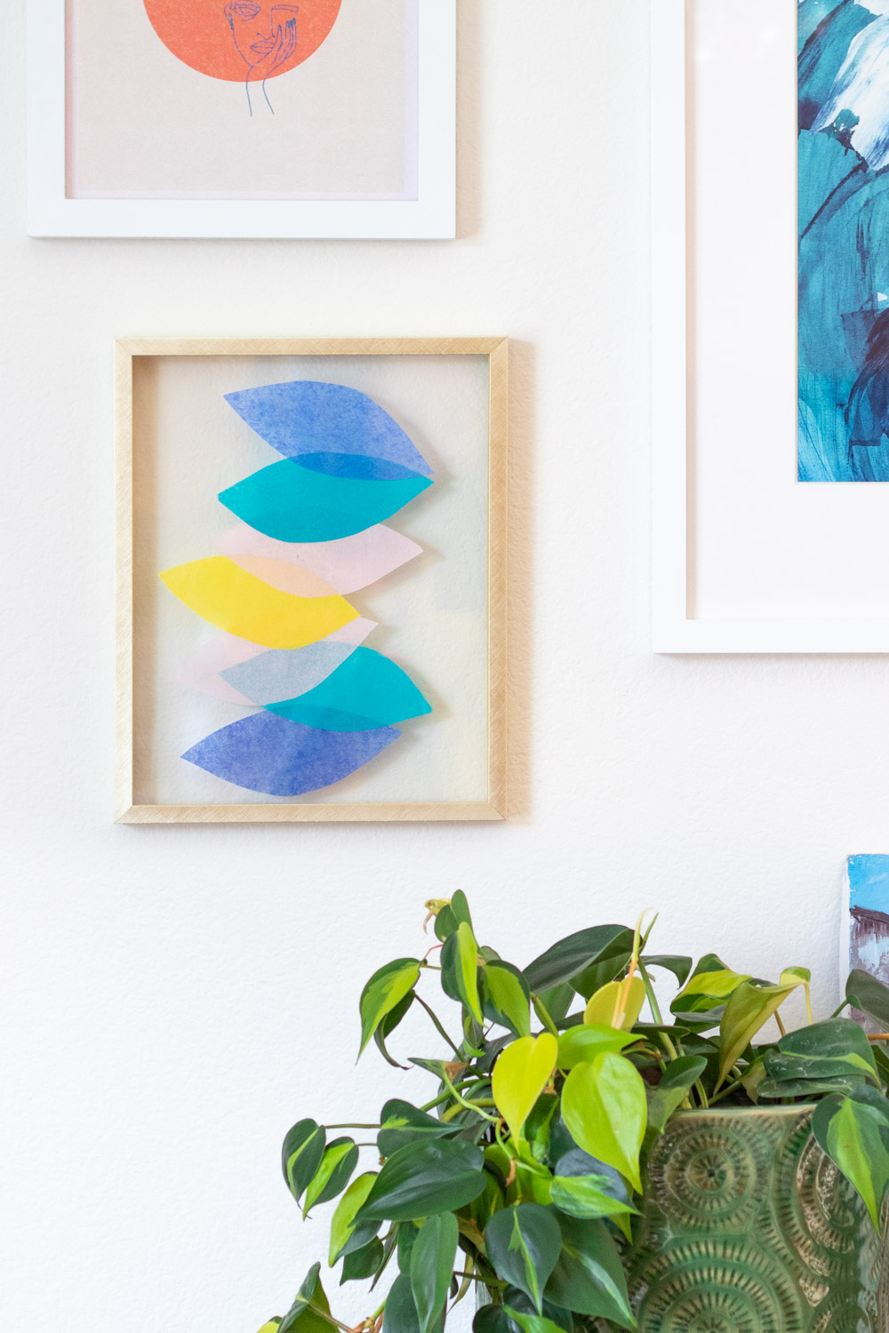 closeup of wall art with tissue paper and plant