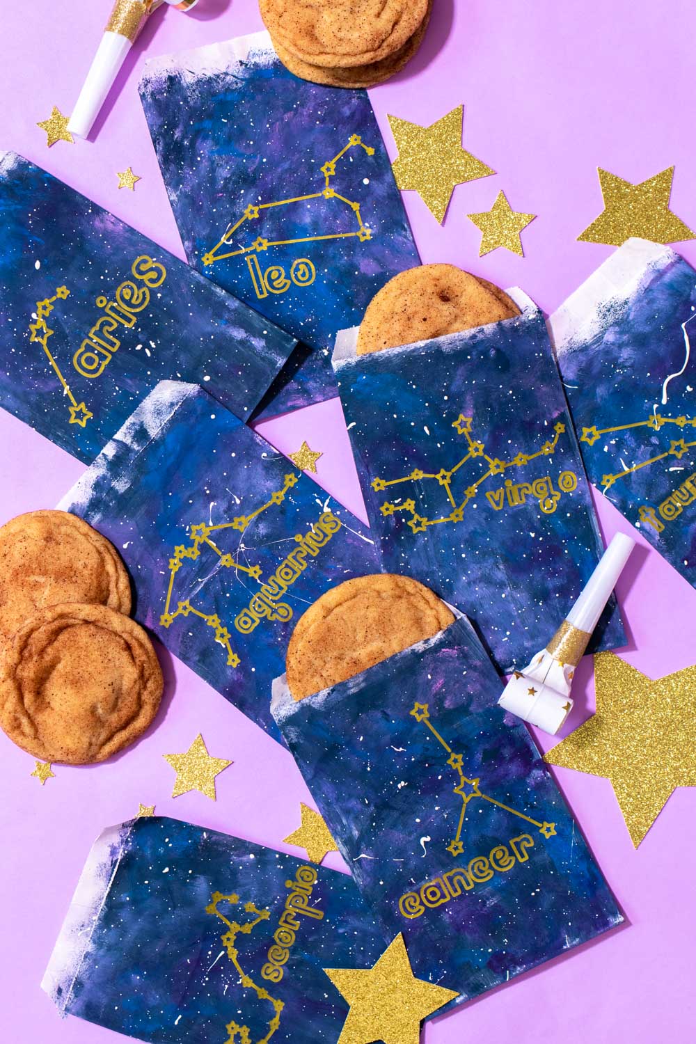 collection of zodiac-themed treat bags with cookies and glitter stars