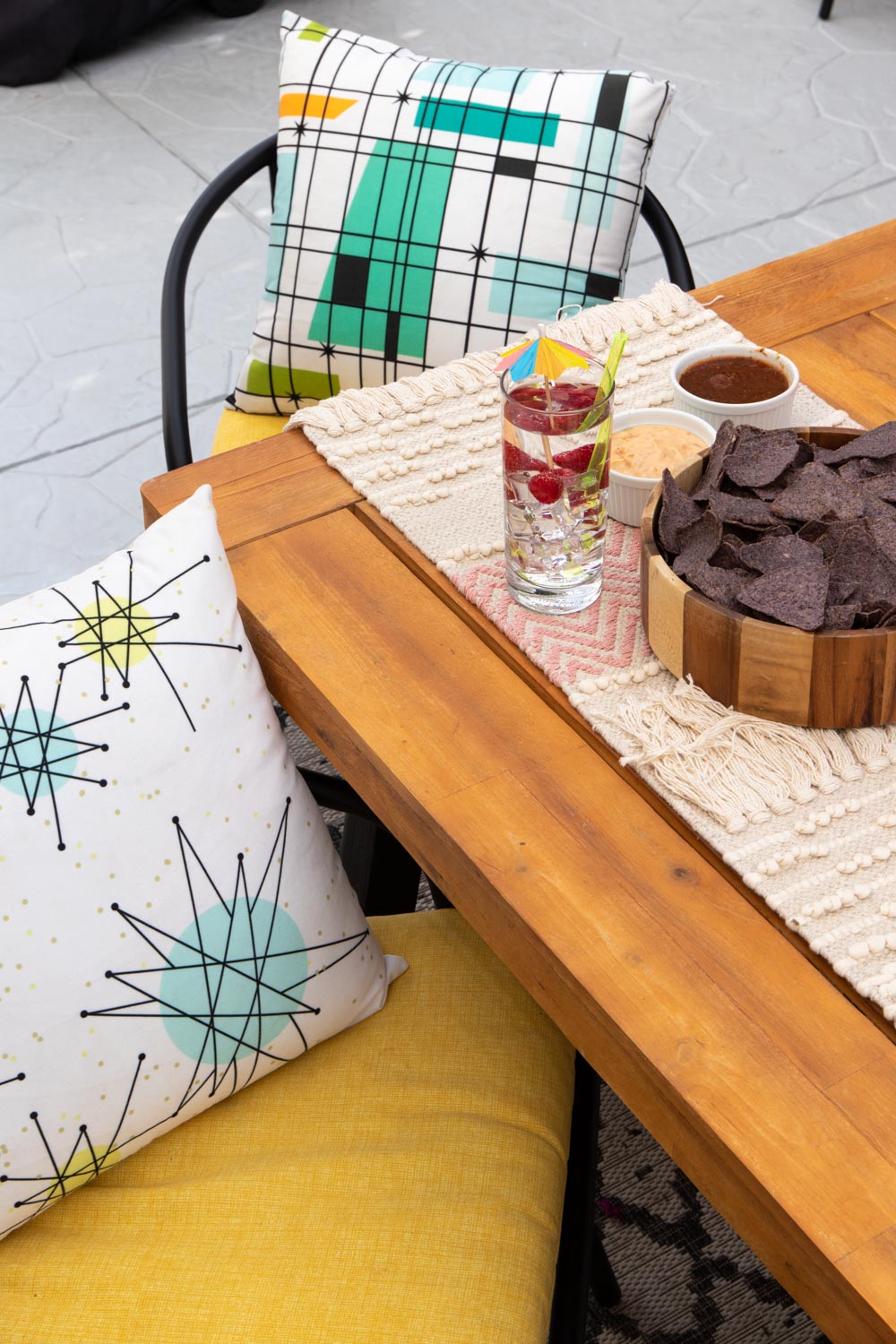 outdoor table with accessories and yellow cushions