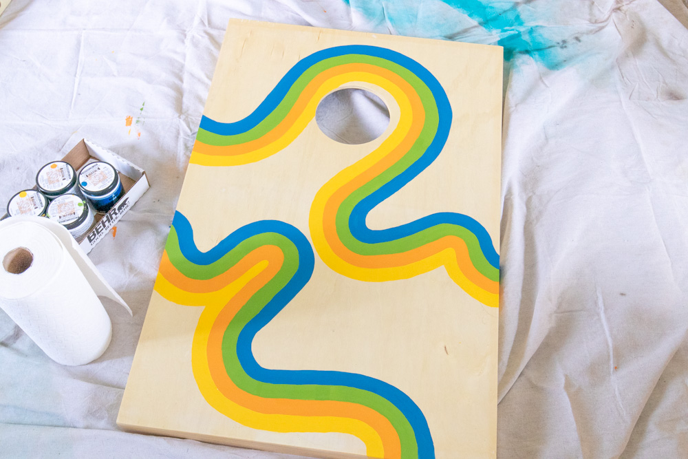 painted retro design on cornhole board