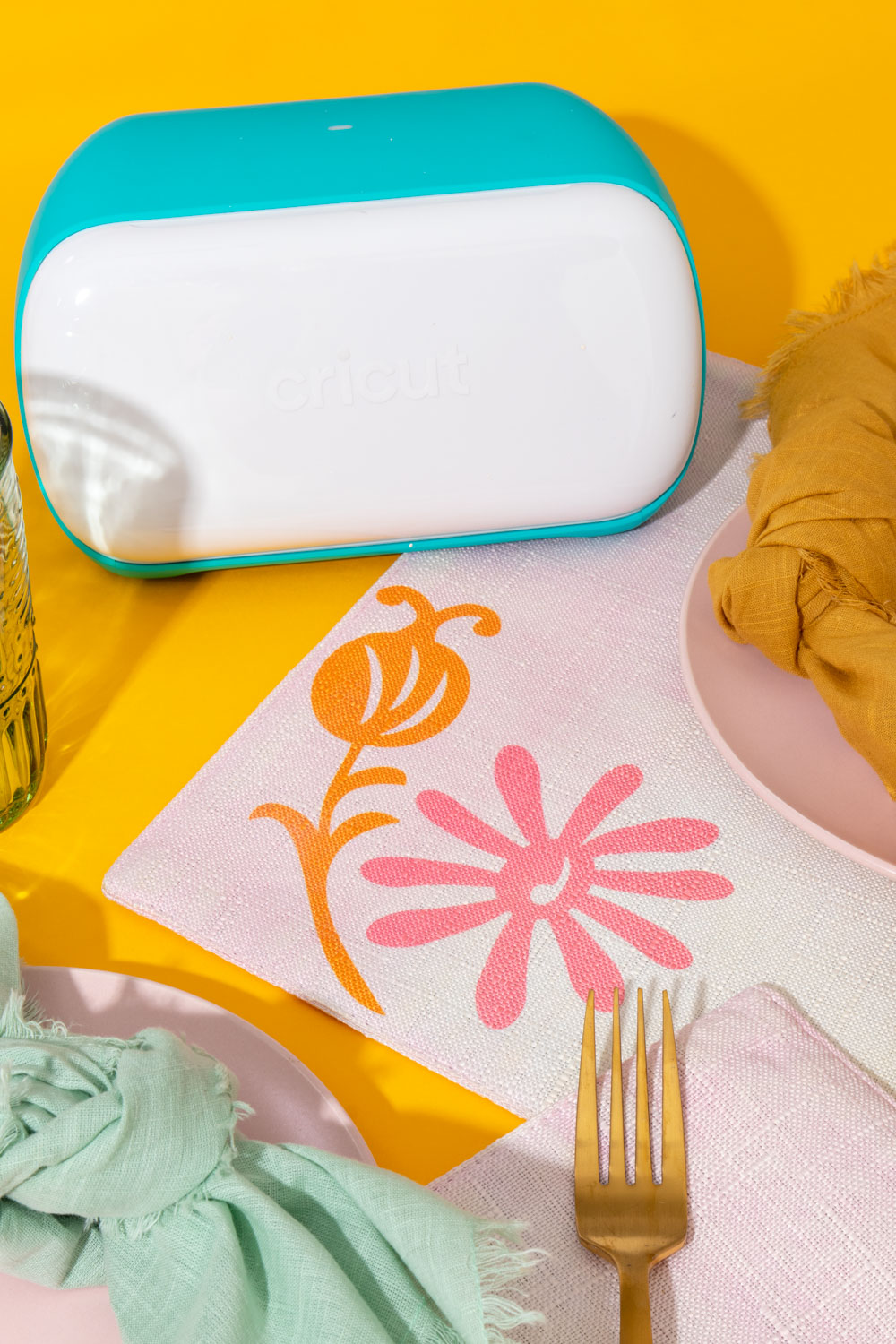 Cricut Joy next to modern placemats with floral pattern